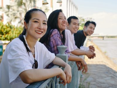 Group of cheerful friends enjoying river view