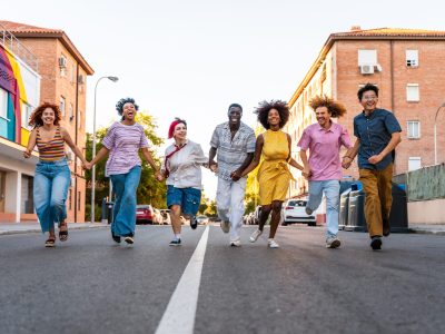 Multiethnic group of young friends meeting and having fun outdoors - Multiracial happy and stylish teen students bonding in the city, concepts about youth, teenagers lifestyle and diversity